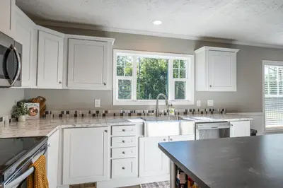 a kitchen with white cabinets and a sink at Wildcat Lodge, Wallingford KY in Wallingford