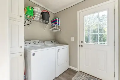 a laundry room with a washer and dryer and a window at Wildcat Lodge, Wallingford KY in Wallingford