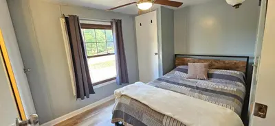 a bedroom with a bed and a window at High Tide Escape