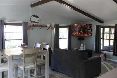 a living room with a table and a dining room at High Tide Escape