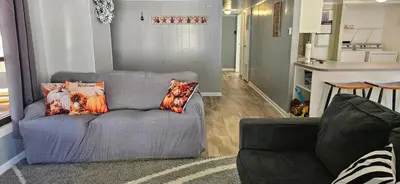 a living room with a blue couch with pillows on it at High Tide Escape