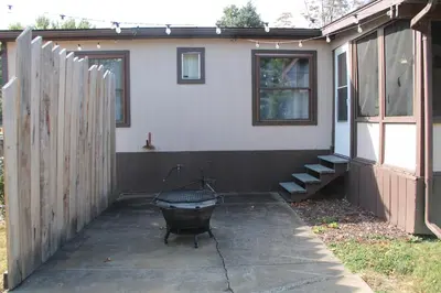 a backyard with a grill in front of a house at High Tide Escape