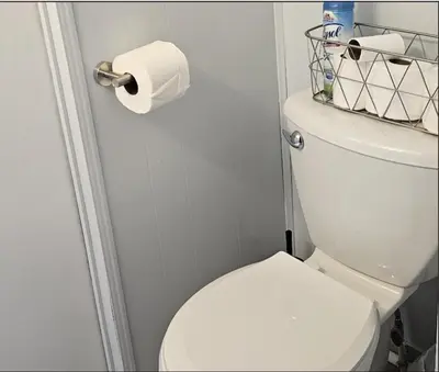 a bathroom with a toilet and a roll of toilet paper at High Tide Escape