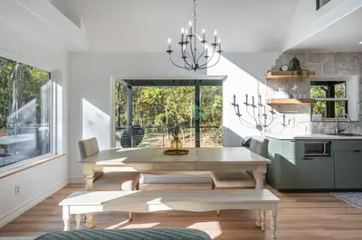a dining room with a table and a kitchen at Tranquility Cove in Dover