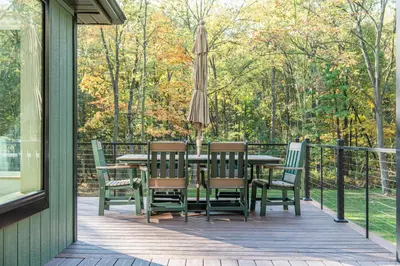 a patio with a table and chairs and an umbrella at Tranquility Cove in Dover