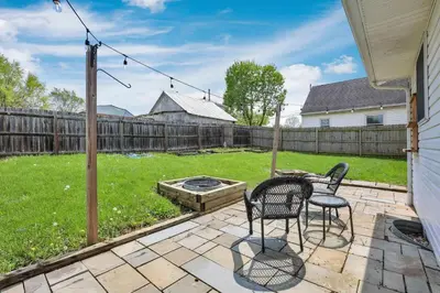a patio with two chairs and a table in a yard at Quiet Ranch Retreat for Work Crews & Families Johnstown OH