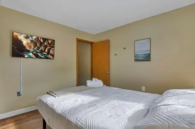 a bedroom with a large bed and a painting on the wall at Spacious 5-Bedroom Retreat in Central Columbus Perfect for Groups in Columbus
