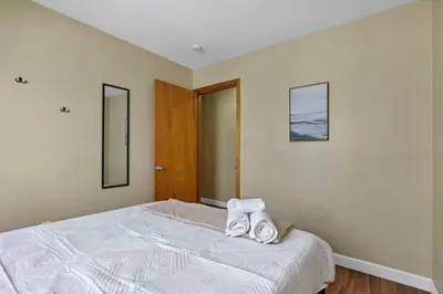 a bedroom with a bed with two towels on it at Spacious 5-Bedroom Retreat in Central Columbus Perfect for Groups in Columbus