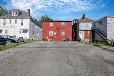 an empty street with a red building and houses at Spacious 5-Bedroom Retreat in Central Columbus Perfect for Groups in Columbus
