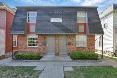 a red brick house with a black roof at Spacious 5-Bedroom Retreat in Central Columbus Perfect for Groups in Columbus