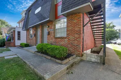 a brick house with a sidewalk in front of it at Spacious 5-Bedroom Retreat in Central Columbus Perfect for Groups in Columbus