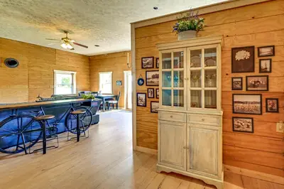 a kitchen with wooden walls and a counter with a cabinet at Ohio Hunters Cabin with Pond Access Pets Welcome!