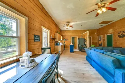 a living room with a blue couch and a table at Ohio Hunters Cabin with Pond Access Pets Welcome!