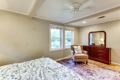 a bedroom with a bed and a mirror and a chair at Large Yard with Pond Family Retreat in New Albany! in New Albany