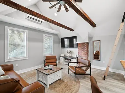 a living room with a couch and a table at Unique BOHO Ohio City Loft Apt in Cleveland