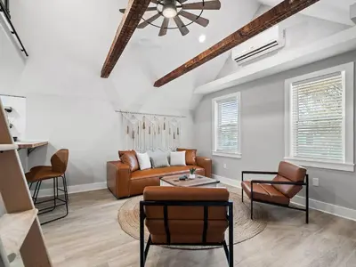 a living room with a couch and two chairs at Unique BOHO Ohio City Loft Apt in Cleveland