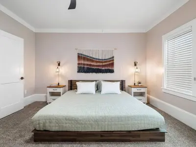 a bedroom with a large bed with two night stands at Amazing Boho Oasis Apartment in Ohio City in Cleveland