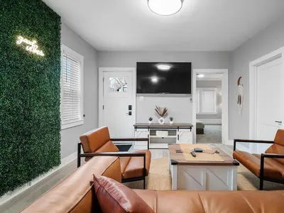 a living room with a couch and a table at Amazing Boho Oasis Apartment in Ohio City in Cleveland