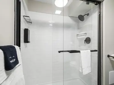 a bathroom with a shower with a glass door at Amazing Boho Oasis Apartment in Ohio City in Cleveland