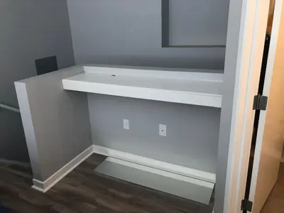 a white shelf in a room with a mirror at Cozy Downtown Modern Condo in the Heart of it all in Cleveland