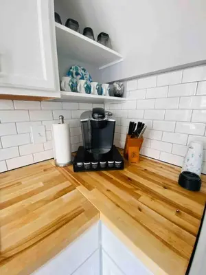 a kitchen counter with a coffee maker on top of it at Cozy Downtown Modern Condo in the Heart of it all in Cleveland