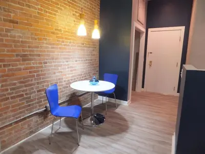 a table and chairs in a room with a brick wall at Renovated Downtown Condo in the HEART OF IT ALL in Cleveland