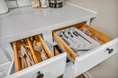 a drawer in a white cabinet filled with utensils at Fenced & Pet-Friendly! Modern 2BR Retreat! CLE-BW in Berea
