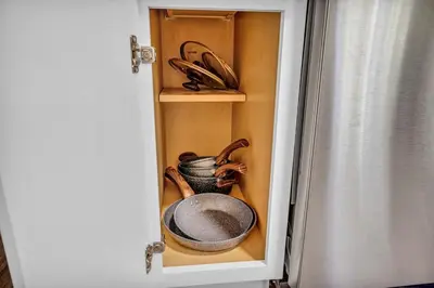 a cupboard with a plate and a bowl in it at Fenced & Pet-Friendly! Modern 2BR Retreat! CLE-BW in Berea