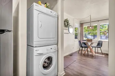 a laundry room with a washing machine and a table at Fenced & Pet-Friendly! Modern 2BR Retreat! CLE-BW in Berea