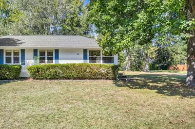 a white house with a tree in the yard at Fenced & Pet-Friendly! Modern 2BR Retreat! CLE-BW in Berea