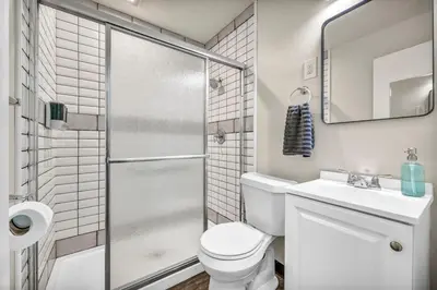 a bathroom with a shower and a toilet and a sink at Fenced & Pet-Friendly! Modern 2BR Retreat! CLE-BW in Berea