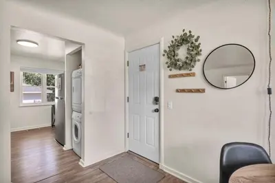 a living room with a door and a mirror at Fenced & Pet-Friendly! Modern 2BR Retreat! CLE-BW in Berea