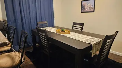 a dining room table with chairs and blue curtains at 3 BDR - Your Perfect Getaway! in Warren
