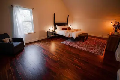 a bedroom with a bed and a large window at The 312 House - A Boho Retreat- Hocking Hills in Logan