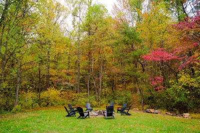a group of chairs and a table in a park at The 312 House - A Boho Retreat- Hocking Hills in Logan
