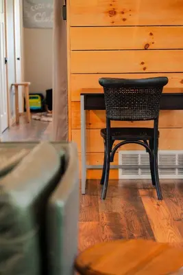 a black chair sitting at a table in a room at The Treetop A Hocking Hills Villa Treat in Logan