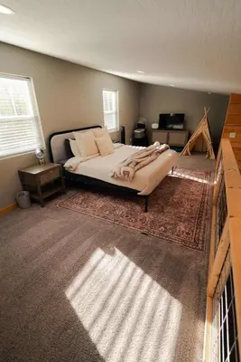 a bedroom with a large bed in a room at The Treetop A Hocking Hills Villa Treat in Logan