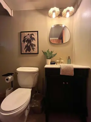 a bathroom with a toilet and a sink and a mirror at Outdoors Sleeps7 Family Getaway Fun Arcade Villa in Rockbridge