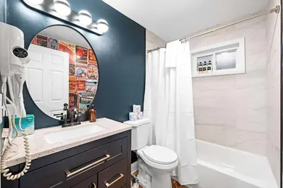 a bathroom with a sink and a toilet and a mirror at 4BR, Home Theater, near Spooky Nook Sports Complex in Hamilton
