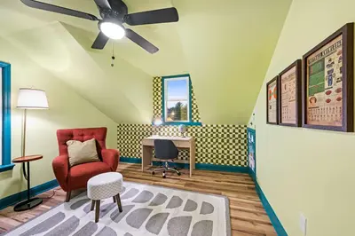 a room with a ceiling fan and a chair and a desk at 4BR, Home Theater, near Spooky Nook Sports Complex in Hamilton