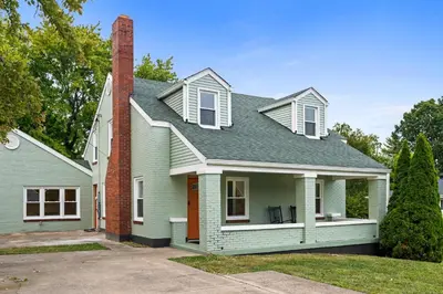 a green house with a brick chimney at 4BR, Home Theater, near Spooky Nook Sports Complex in Hamilton