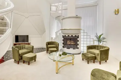 a living room with chairs and a fireplace at Walk to School House Winery Home with Deck! in Dover