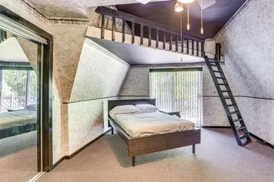 a bedroom with a bunk bed and a ladder at Walk to School House Winery Home with Deck! in Dover