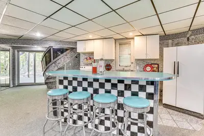 a kitchen with a blue counter and stools at Walk to School House Winery Home with Deck! in Dover