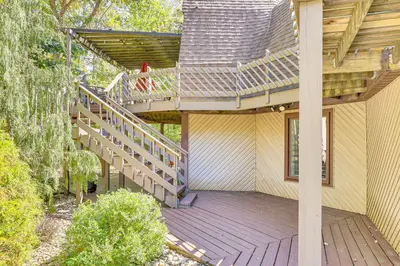 a house with a wooden deck with a staircase at Walk to School House Winery Home with Deck! in Dover