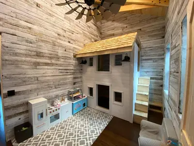 a room with a play kitchen with a wooden wall at Lake Therapy at The ARK | Gameroom, Hot Tub, Dock in Williamstown