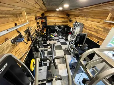 a gym with several tread machines in a room at Lake Therapy at The ARK | Gameroom, Hot Tub, Dock in Williamstown