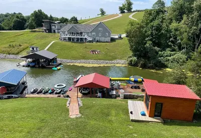 an aerial view of a house and a lake with boats at Lake Therapy at The ARK | Gameroom, Hot Tub, Dock in Williamstown