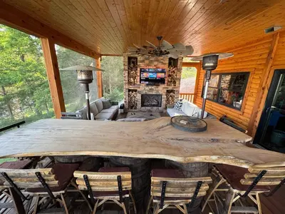 a dining room with a large wooden table and chairs at Lake Therapy at The ARK | Gameroom, Hot Tub, Dock in Williamstown