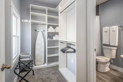 a bathroom with a closet with a toilet and a sink at Prime Walnut Hills, 5min to UC, Lux King Beds, Sleep 6ppl, Smart TVs in Cincinnati